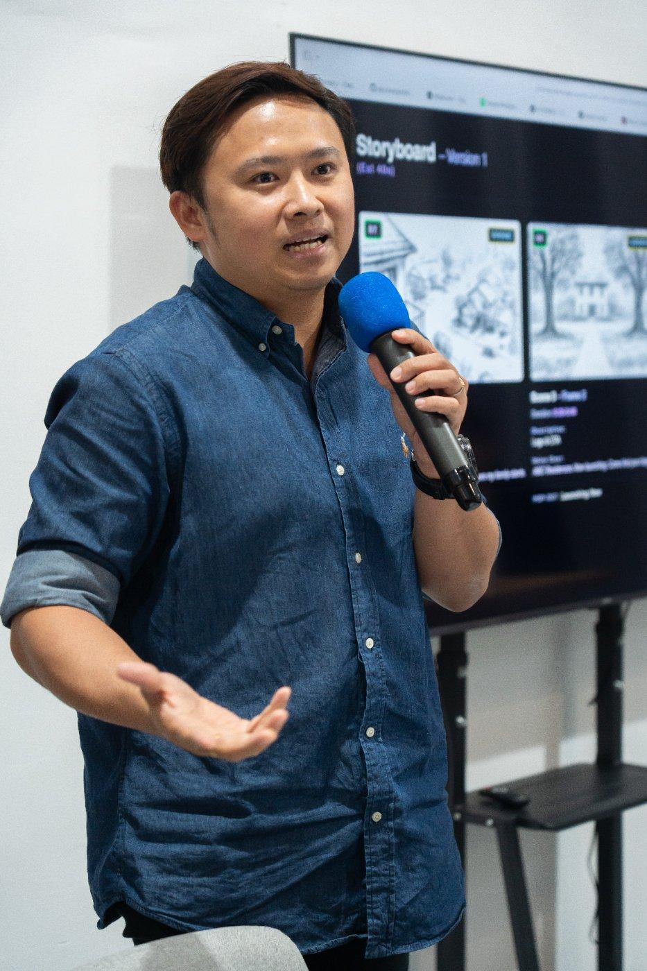 Trainer presenting with mic, mid-sentence